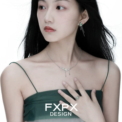 Stylish FXPX lotus pendant necklace worn by a model in a green dress, showcasing elegance and beauty