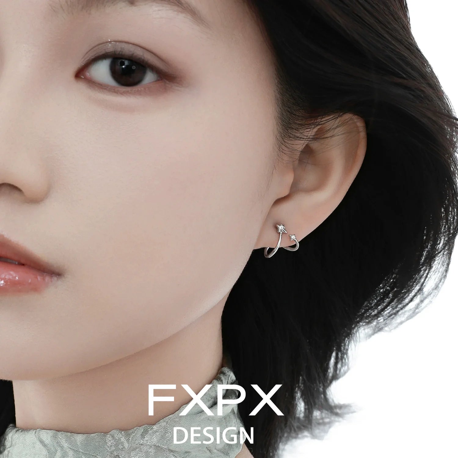 Stylish FXPX meteor silver earrings showcased on a model's ear for a modern look