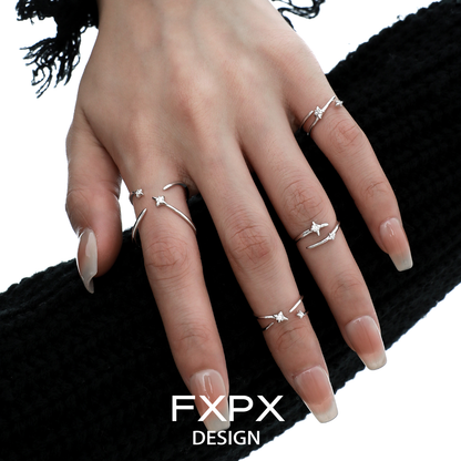 Stylish FXPX meteor track silver ring showcased on a hand with multiple rings for a fashionable look