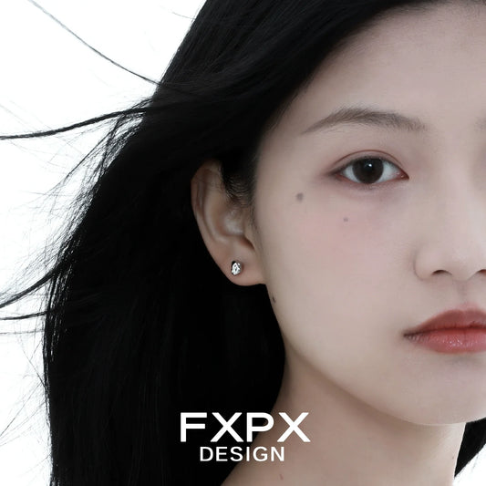 Stylish FXPX meteorite stud earrings showcasing a sleek and modern design on a model's ear