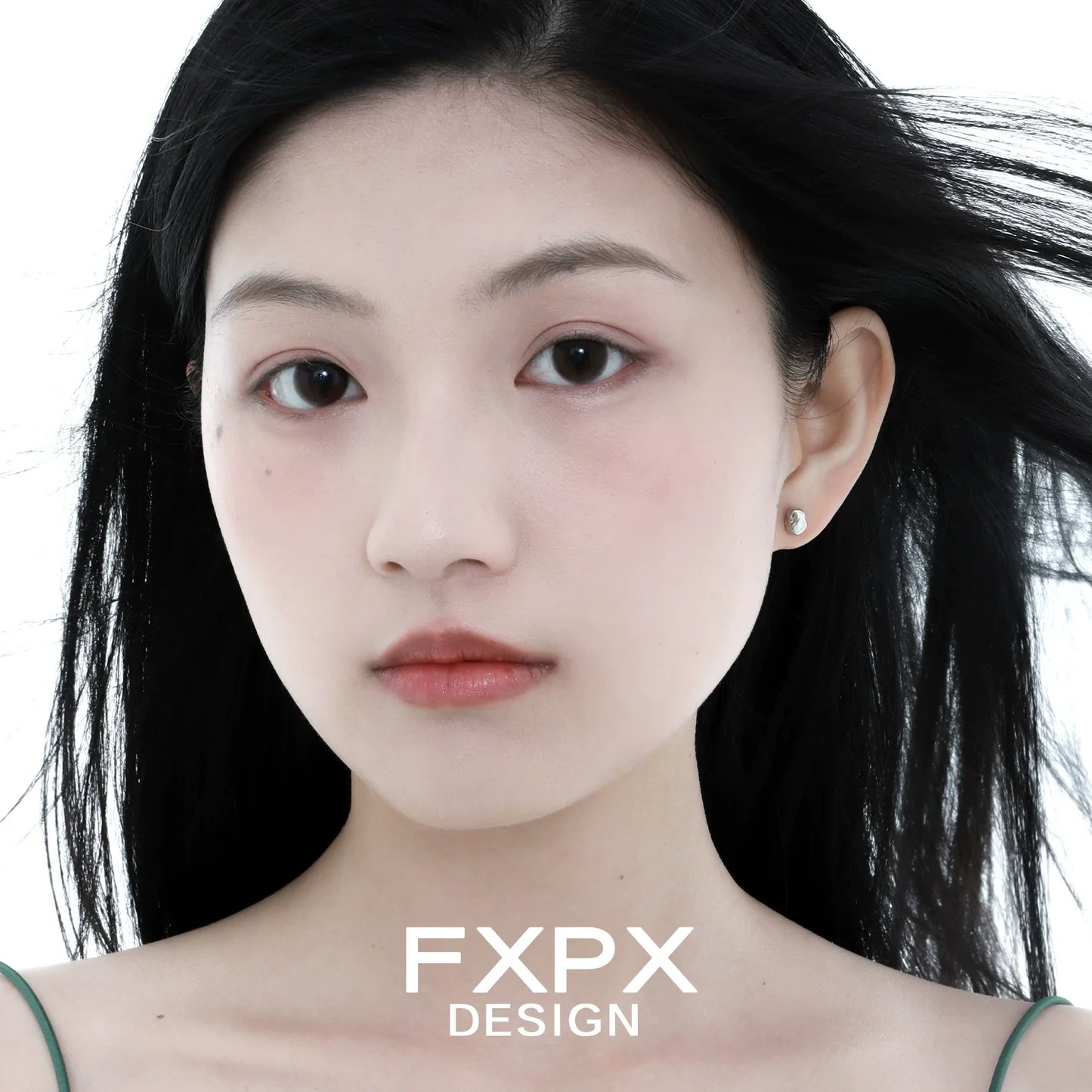 Elegant FXPX meteorite stud earrings showcased on a model with flowing hair
