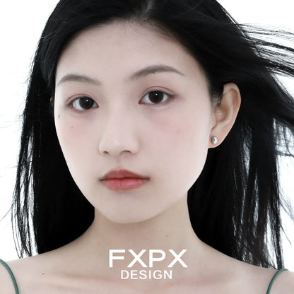 Elegant FXPX meteorite stud earrings showcased on a model with flowing hair