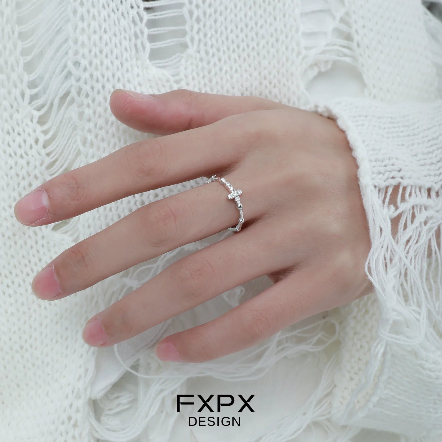 Minimalist cross silver ring displayed on a hand, perfect for daily wear and elegant style.