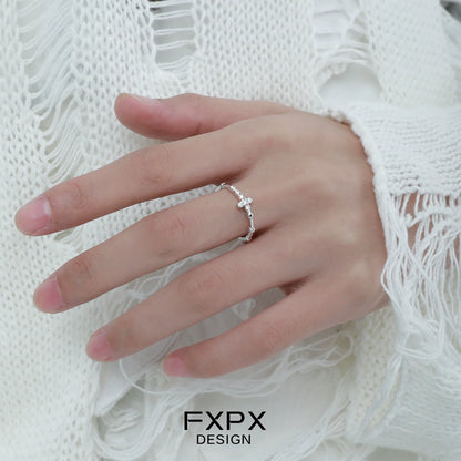 Minimalist cross silver ring displayed on a hand, perfect for daily wear and elegant style.
