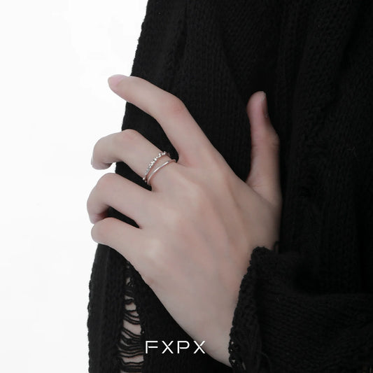Elegant minimalist double layer ring showcased on a model's hand with a black sweater