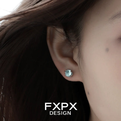 FXPX minimalist glacier earrings featured on a model's ear with a soft, elegant design