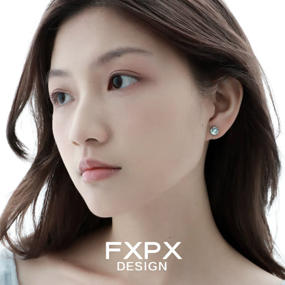 FXPX minimalist glacier earrings displayed on a model with natural makeup and long hair