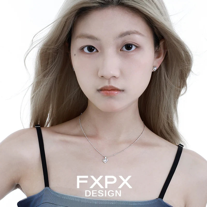 FXPX moonstone heart pendant necklace worn by model with silver chain and minimalist design