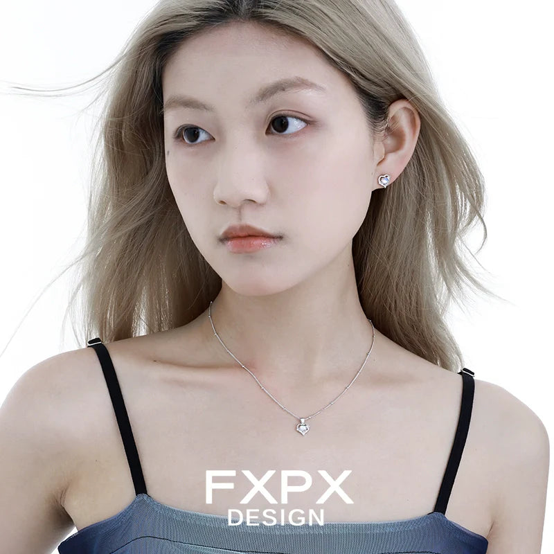 Delicate FXPX moonstone heart pendant necklace worn by a model with a sleek hairstyle