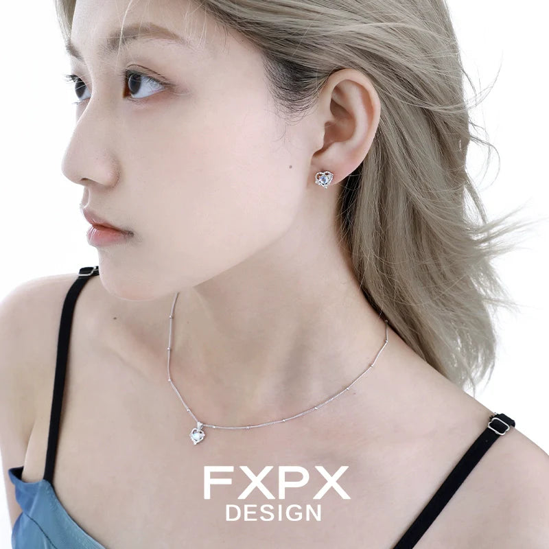 Woman wearing FXPX moonstone heart pendant necklace and earrings, showcasing elegant jewelry style
