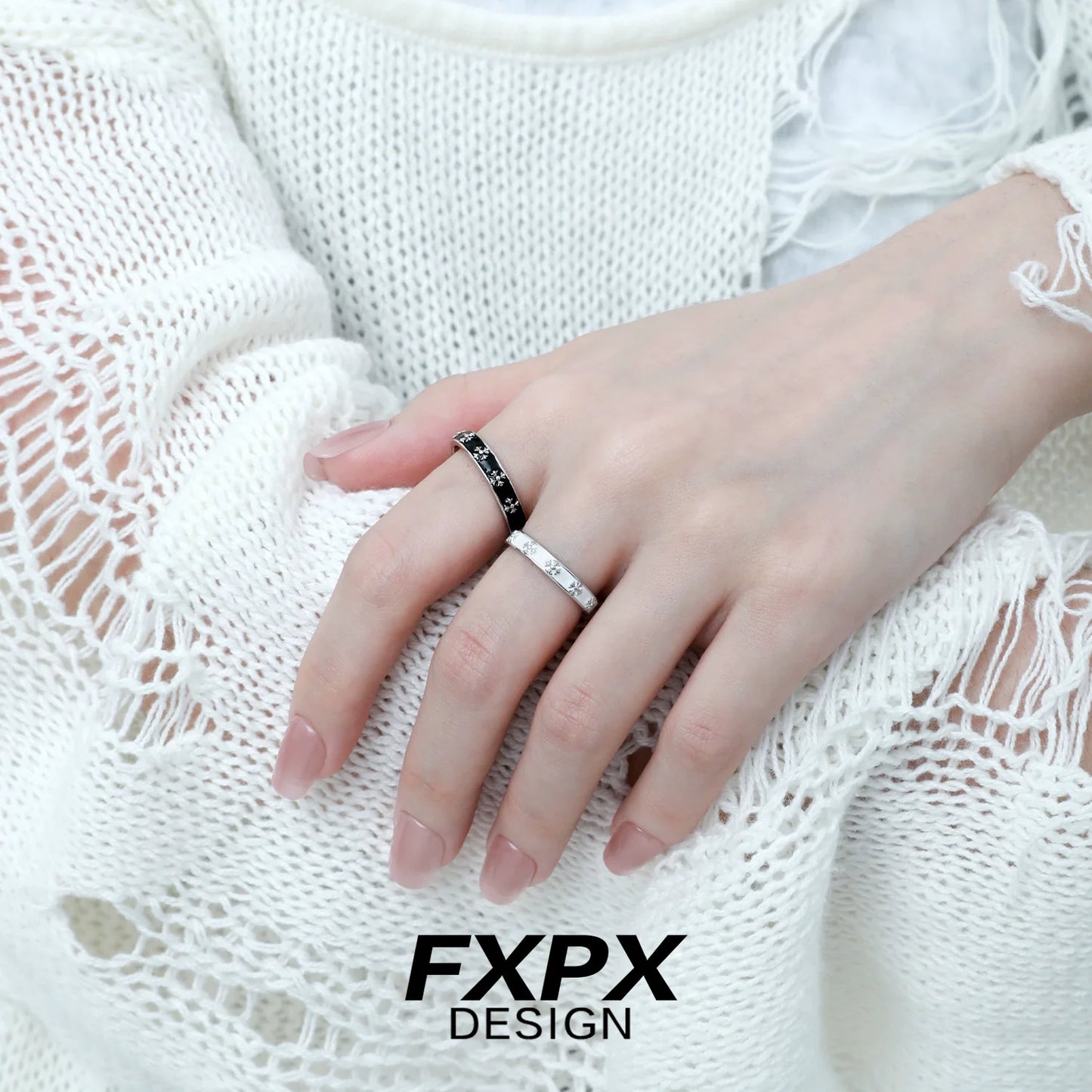 Stylish FXPX mystery couple rings featuring a sleek design on a model's hand
