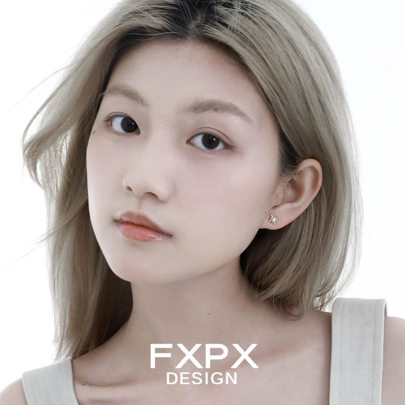 Mystic gold star earrings worn by a model with light hair and a minimalist look