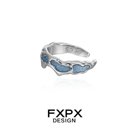 Silver FXPX mystic island ear cuff featuring a textured design with blue accents