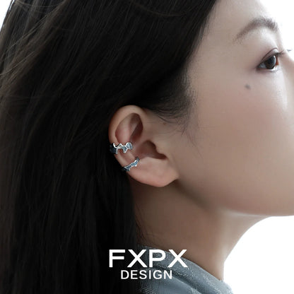 FXPX Mystic Island Ear Cuff displayed on a model's ear showcasing its unique design and stylish appeal