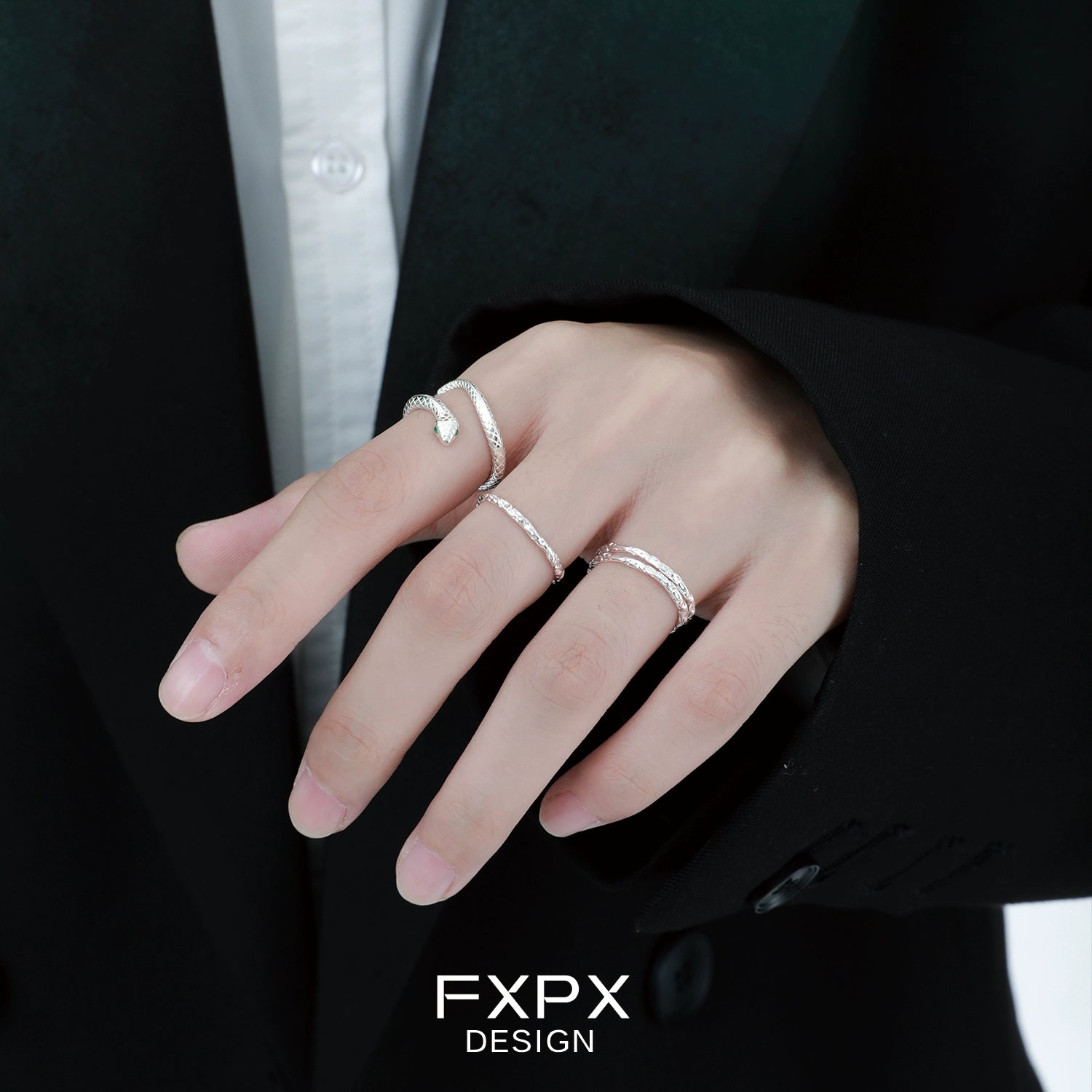 FXPX Ouroboros silver ring worn on a model's hand with two additional silver bands for stylish layering