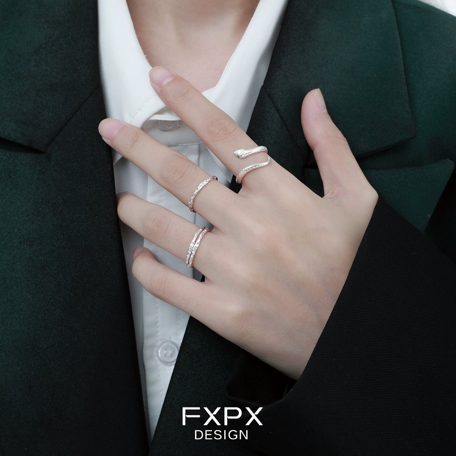 Model wearing a stylish Ouroboros silver ring alongside other elegant rings for a modern look