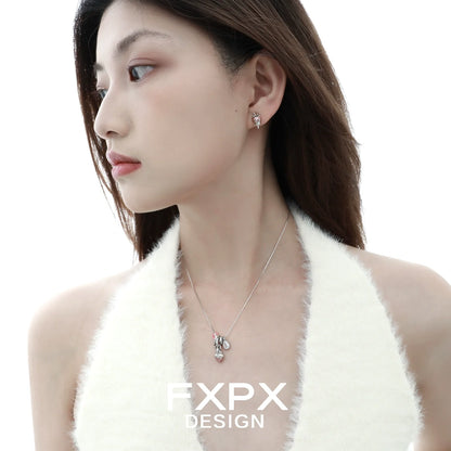 Stylish pink strawberry stud earrings from FXPX worn by a model for a chic look