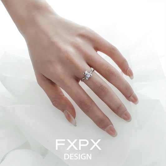 Elegant FXPX purple zircon bear ring showcased on a delicate hand against a soft backdrop