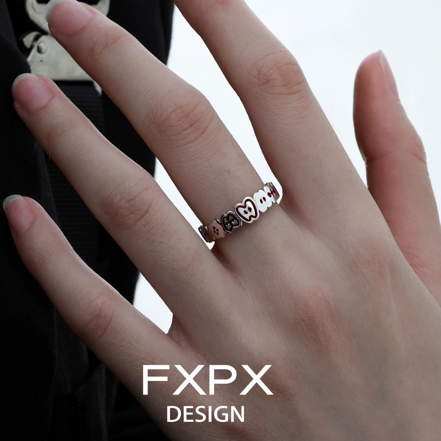 Stylish FXPX red green apple ring on a finger, perfect for trendy accessory lovers