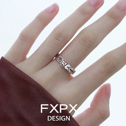 Stylish FXPX red green apple ring on a hand, perfect for playful fashion accessories