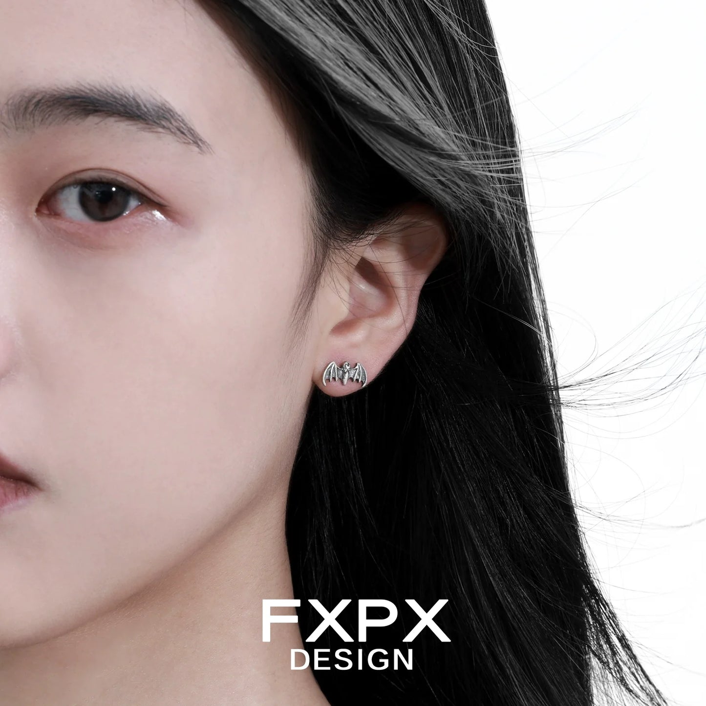 FXPX retro bat stud earrings worn by a model with flowing hair for a stylish look