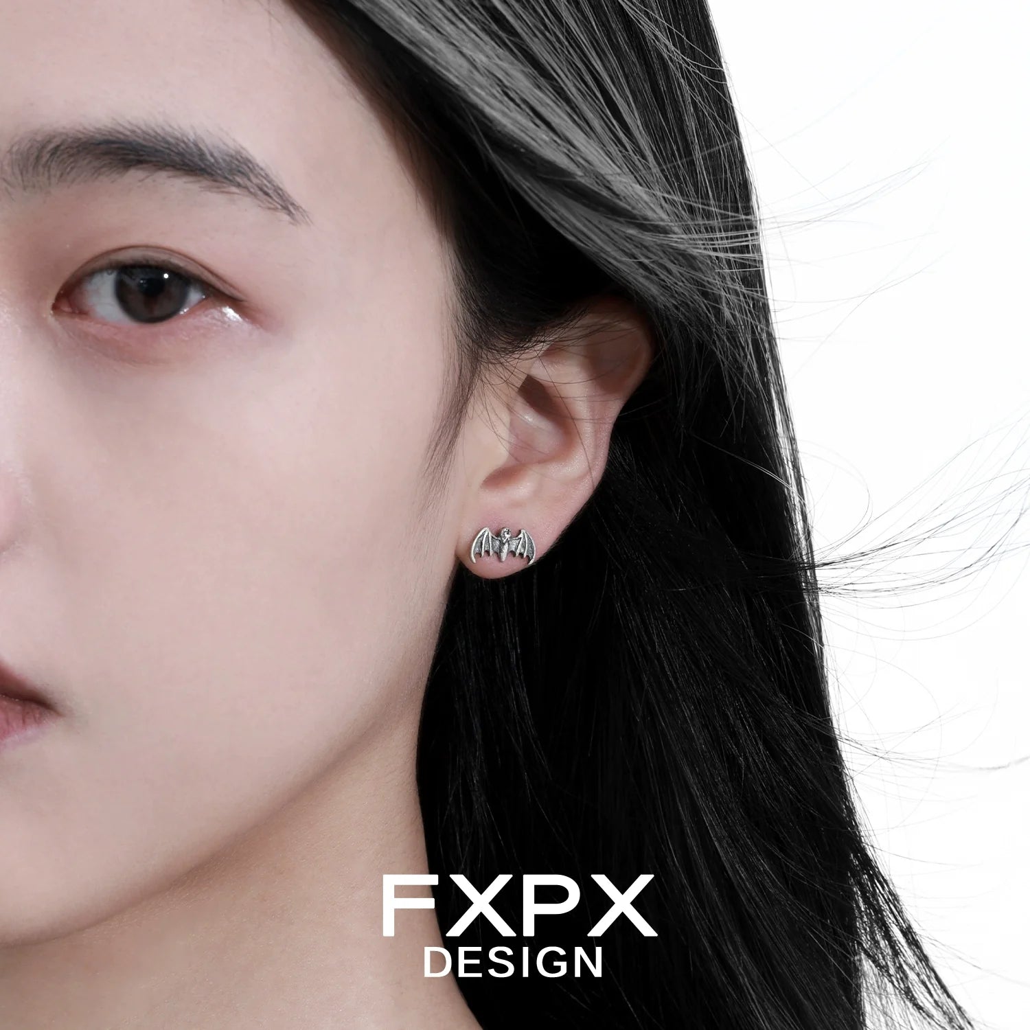 FXPX retro bat stud earrings worn by a model with flowing hair for a stylish look