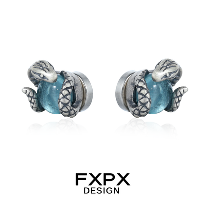 FXPX serpent ear cuffs featuring silver snakes wrapped around blue gemstones for a unique accessory