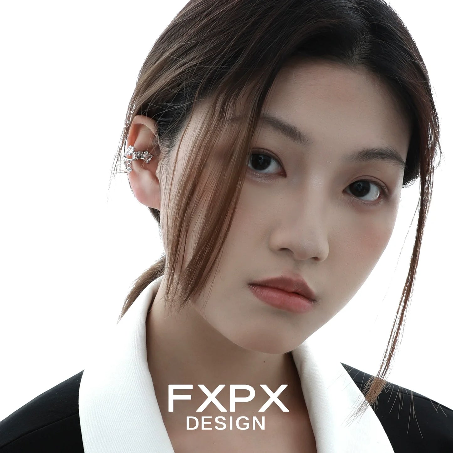 Model wearing FXPX shattered prism zircon ear cuff, showcasing a modern and elegant design