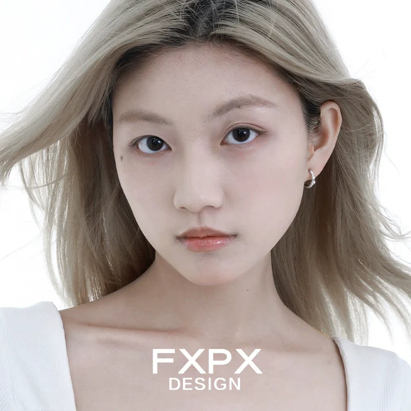 Model wearing FXPX shattered star silver earrings, showcasing modern and elegant design