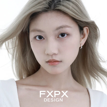 Model wearing FXPX shattered star silver earrings, showcasing modern and elegant design