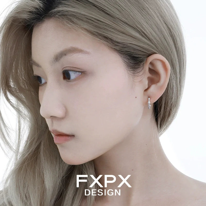 Model showcasing FXPX shattered star silver earrings with elegant design and subtle sparkle