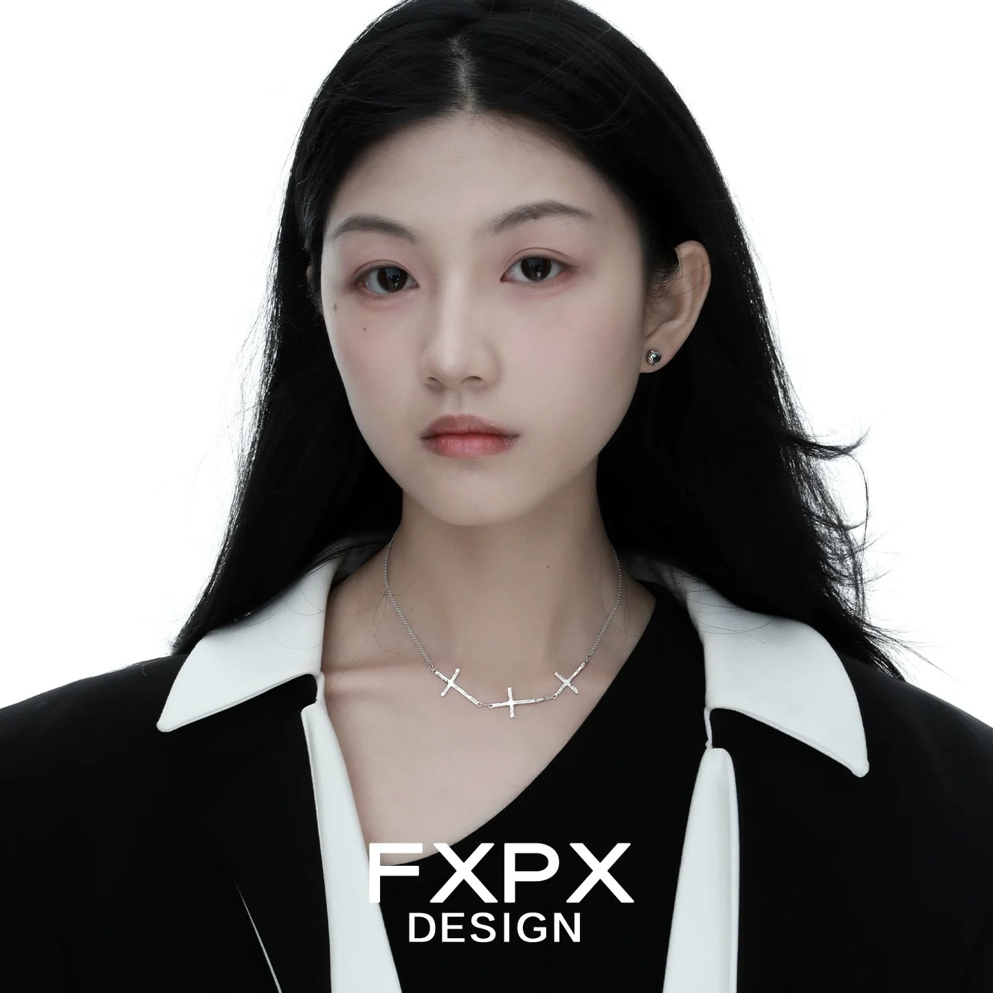 Elegant FXPX silver cross necklace worn by model against white background