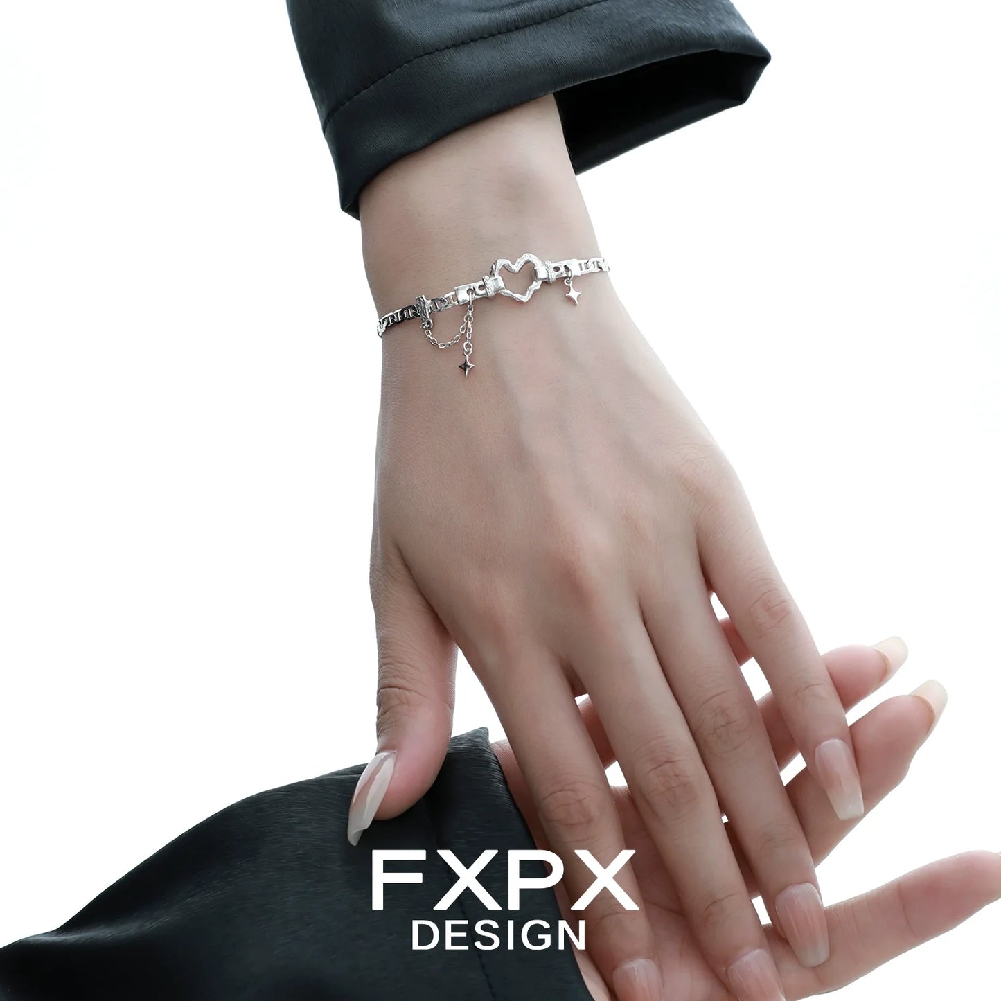 Silver geometric heart bracelet by FXPX showcased elegantly on a woman's wrist
