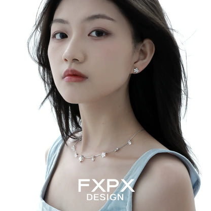 Elegant silver star necklace by FXPX featuring delicate star pendants for a stylish look