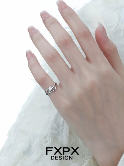 Elegant FXPX silver wave zircon ring displayed on a model's hand with a delicate design