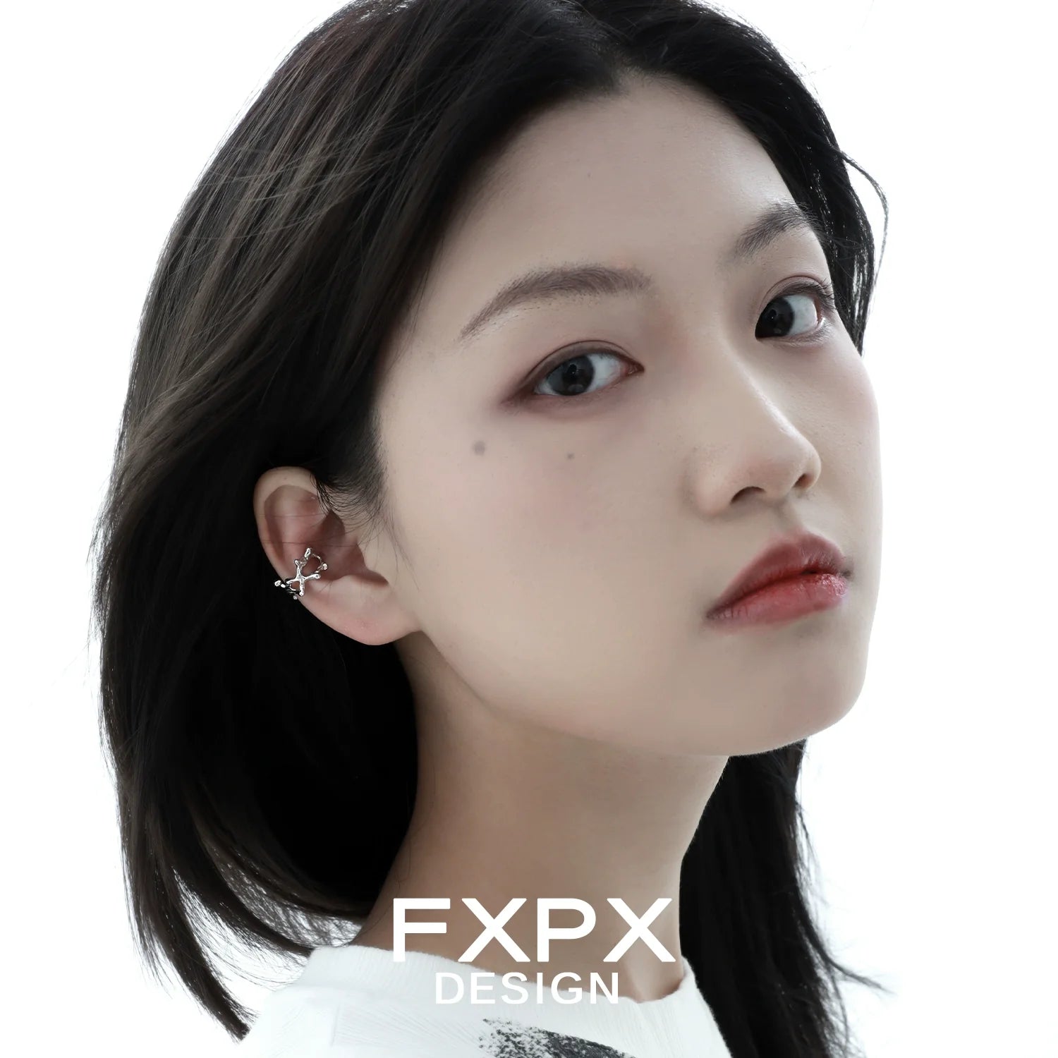 FXPX special shaped silver ear cuff worn elegantly by a model with straight hair