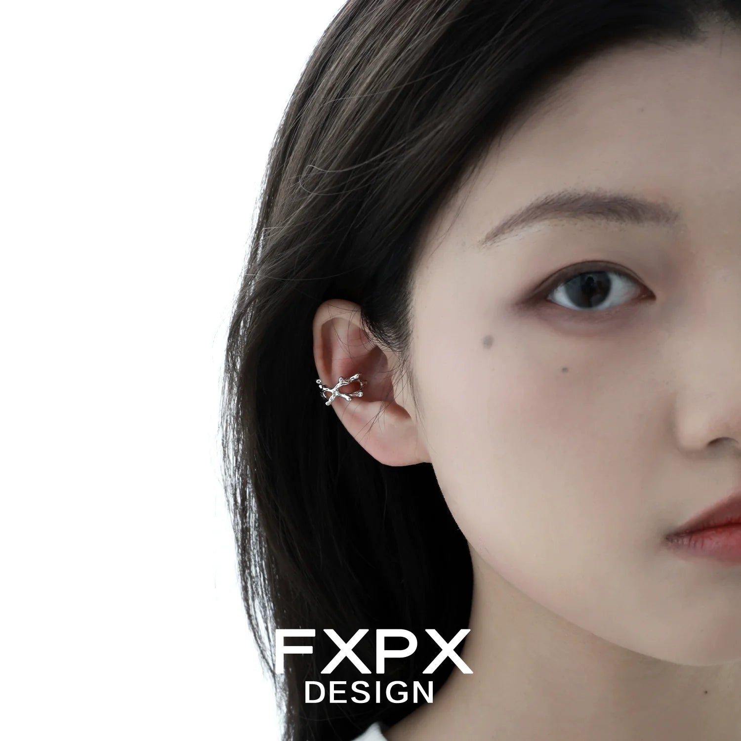 Model wearing special shaped silver ear cuff, showcasing its unique design and elegant look