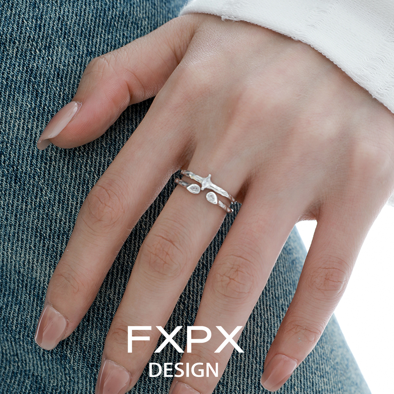 FXPX Design star gaze couple rings showcased on a hand with delicate leaf patterns