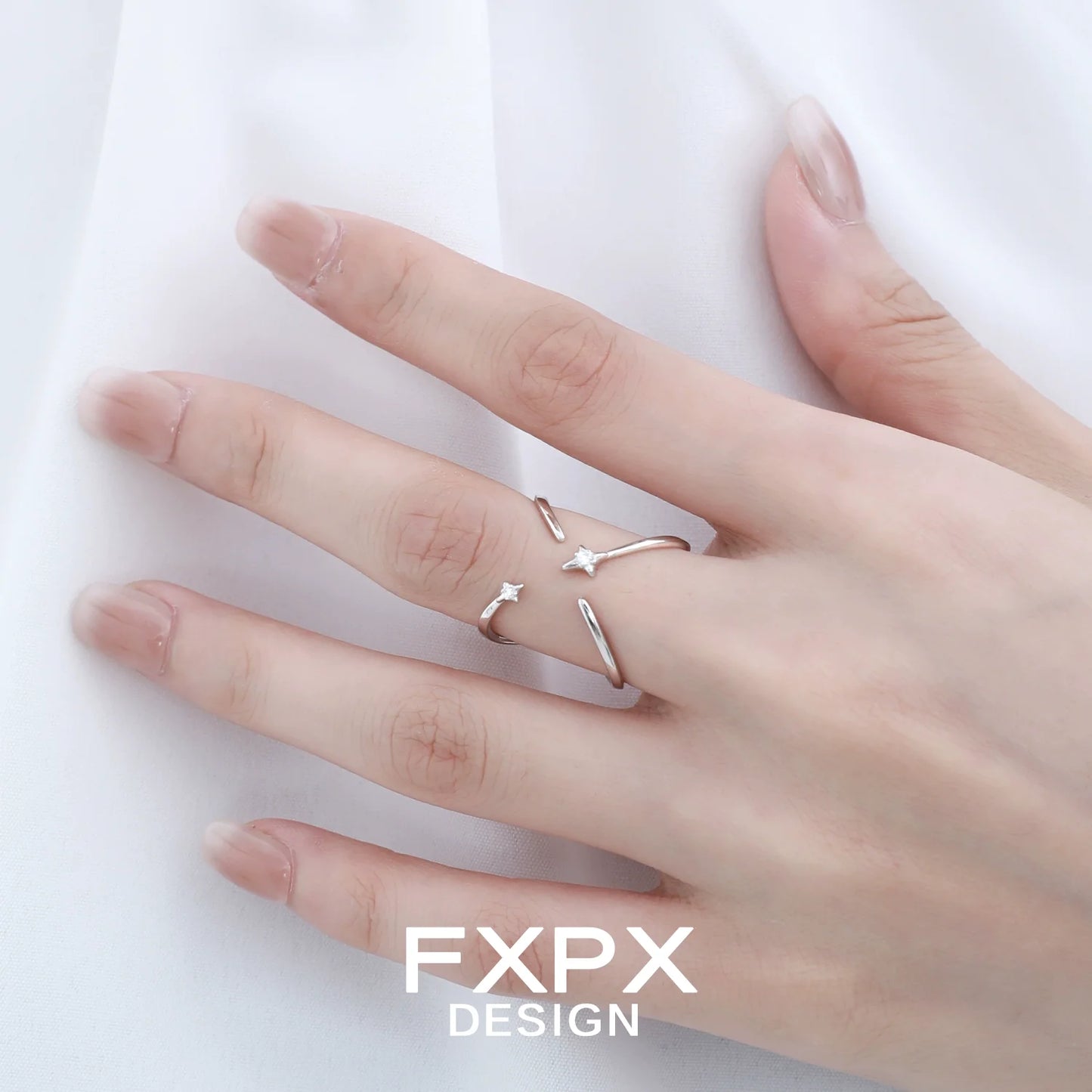 Delicate FXPX star silver ring on a hand, ideal for adding a touch of elegance to your jewelry collection