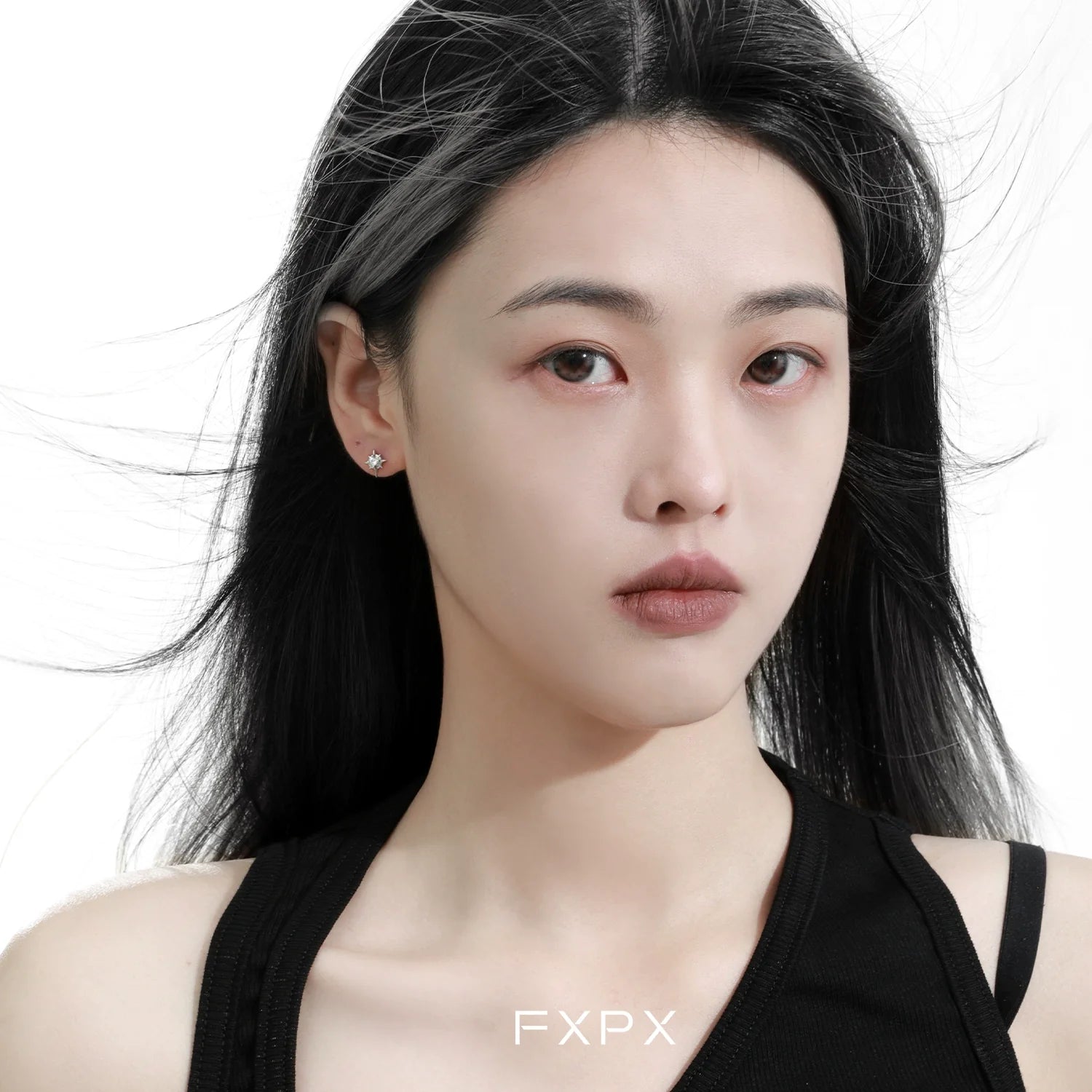 Stylish FXPX star stud earrings showcased on a model with flowing hair