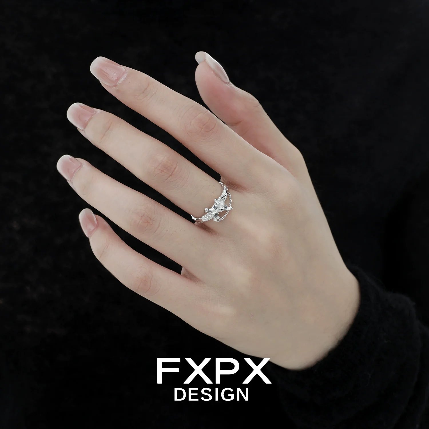 FXPX sword cross ring displayed on a model's hand, featuring intricate design and silver finish