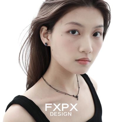 Elegant FXPX Tanzanian blue black rose necklace worn by a model with natural makeup