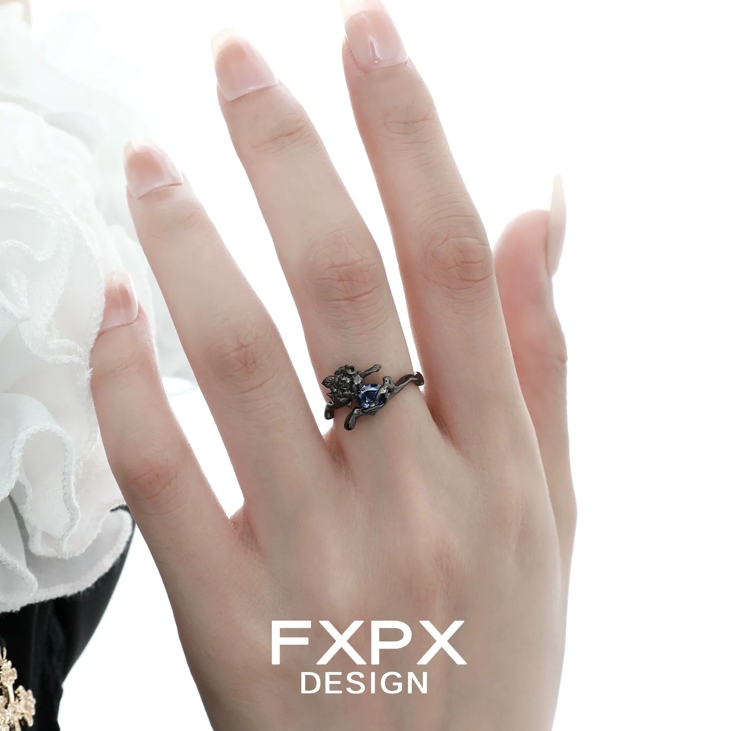 Elegant FXPX Tanzanian blue rose ring featuring a detailed floral design on a hand