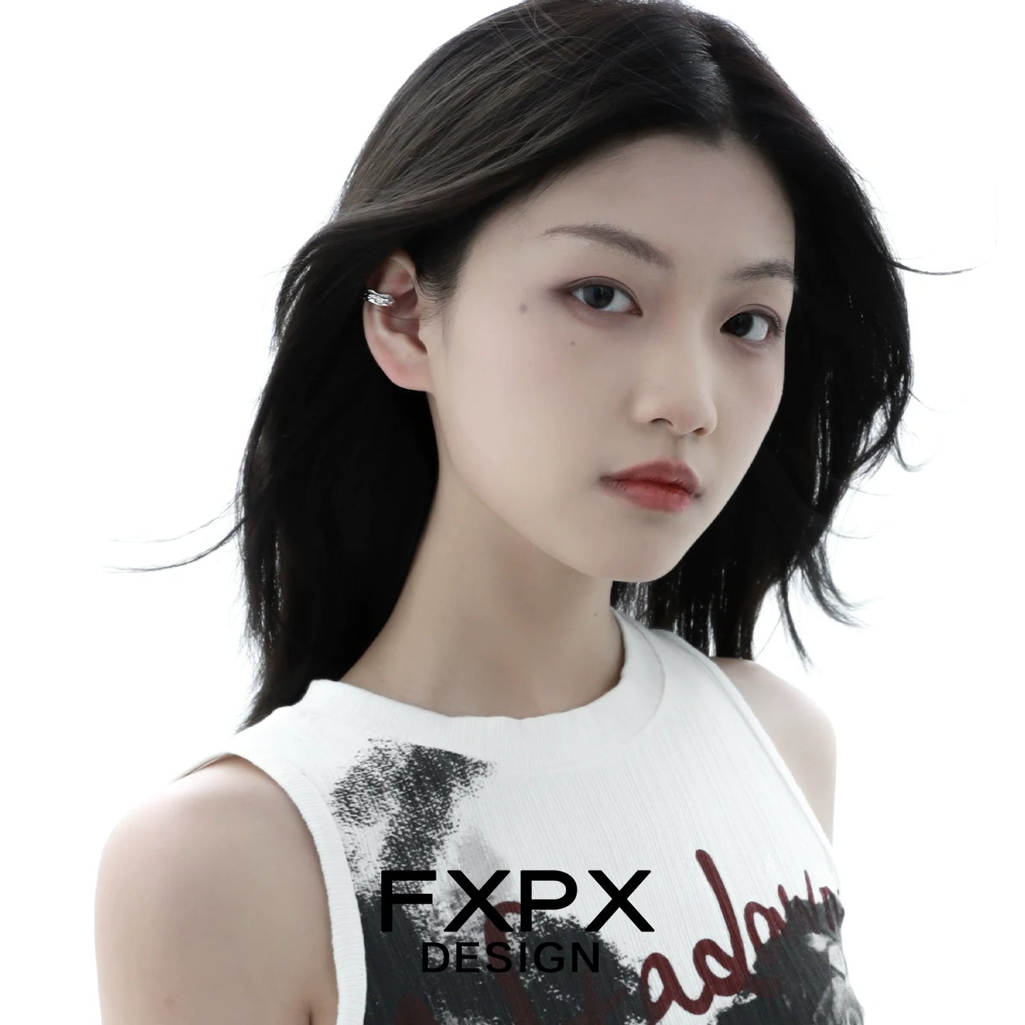 Model showcasing a textured silver ear cuff from FXPX, enhancing modern elegance and style