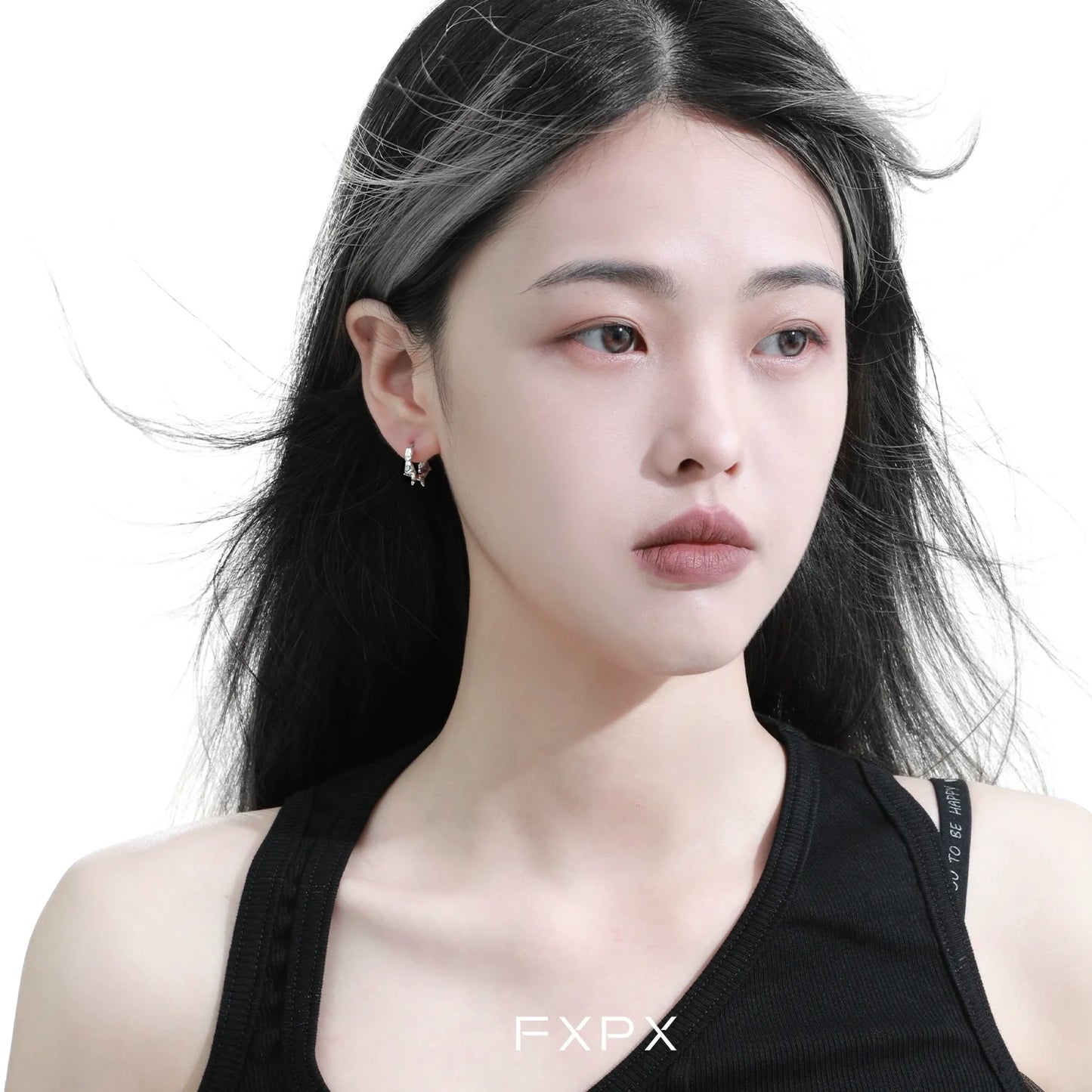 Stylish FXPX thorn silver hoop earrings worn by a model with flowing hair