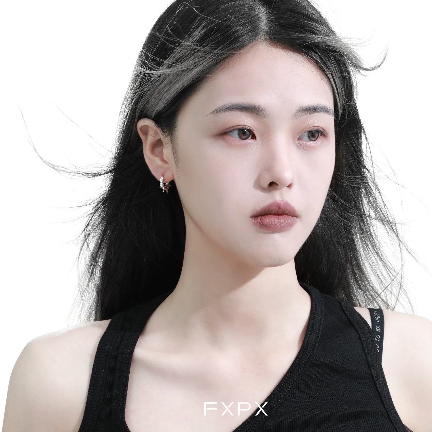 Stylish FXPX thorn silver hoop earrings worn by a model with flowing hair