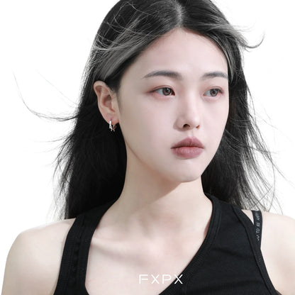 Stylish FXPX thorn silver hoop earrings worn by a model with flowing hair