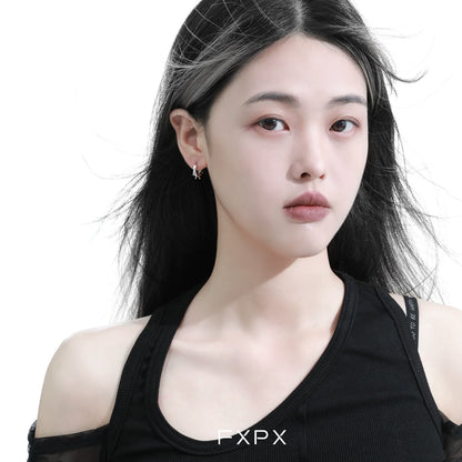 Stylish thorn silver hoop earrings worn by a model showcasing contemporary fashion
