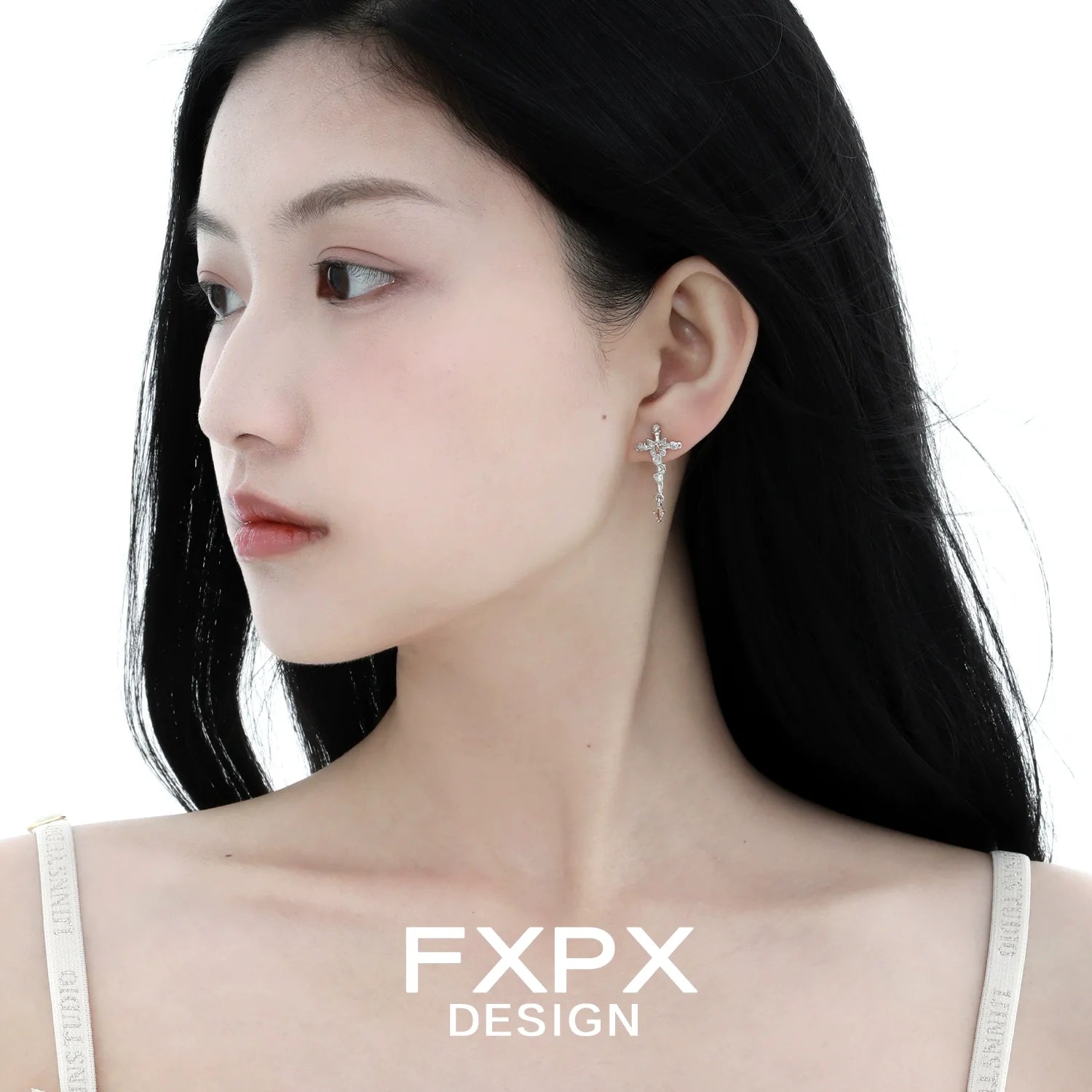 Silver thorned butterfly cross earrings designed by FXPX, elegantly worn by a model