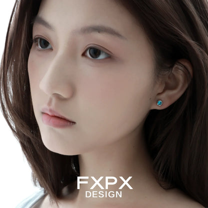 Turquoise blue screw stud earrings showcased on a model with light brown hair and a natural makeup look
